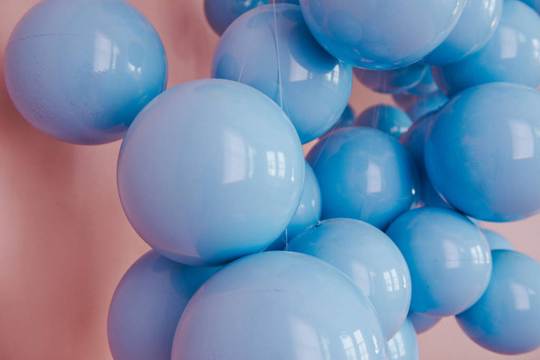 Blue balls on a pink background. Wedding or birthday decoration. Bright background - Foto, Imagen