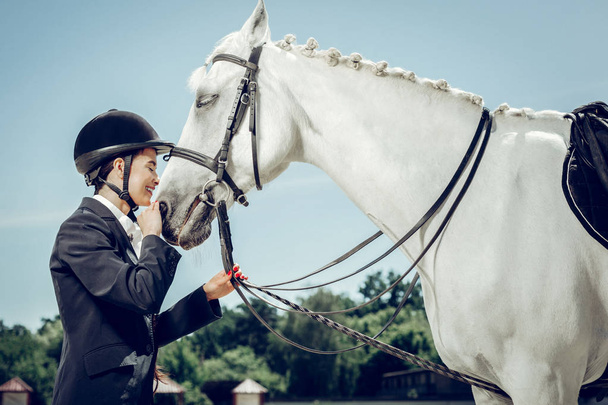 Nice beautiful woman standing in front of her horse - 写真・画像