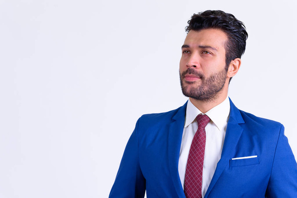 Portrait of handsome bearded Persian businessman thinking - Photo, Image