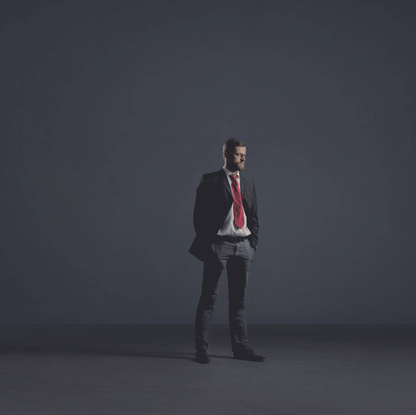 Businessman in formalwear over dark dramatic background. Business, finance, career and office concept. - Zdjęcie, obraz