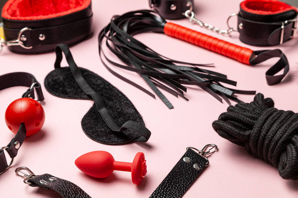 Set of erotic toys for BDSM. The game of sexual slavery with handcuffs, whip, gag and leather straps. Intimate games. - Photo, Image