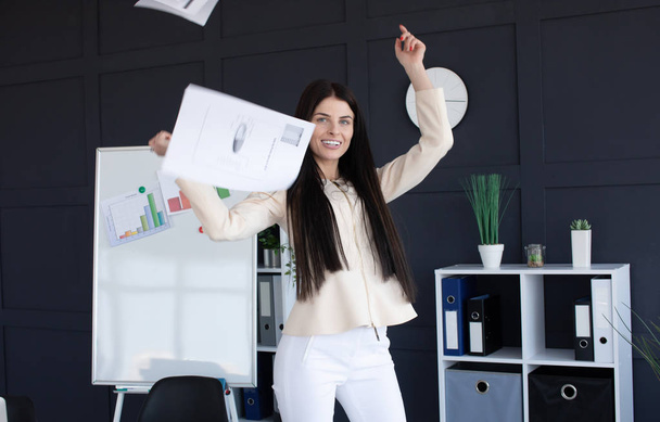 Young businesswoman throws paper document pages in office. - Fotó, kép