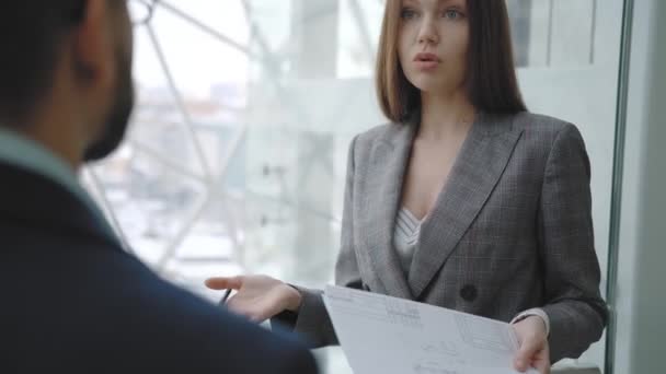 Business woman communicates with partner, smiles, holding a document. - Felvétel, videó