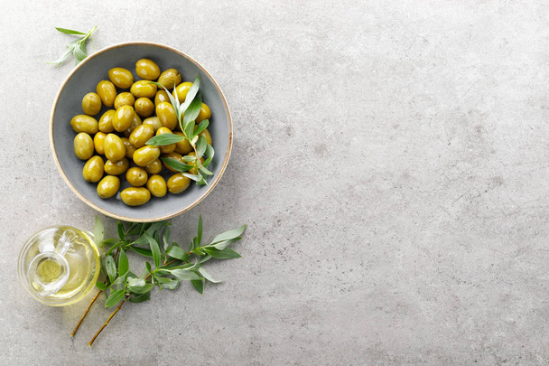 Green olives in a bowl - Fotó, kép