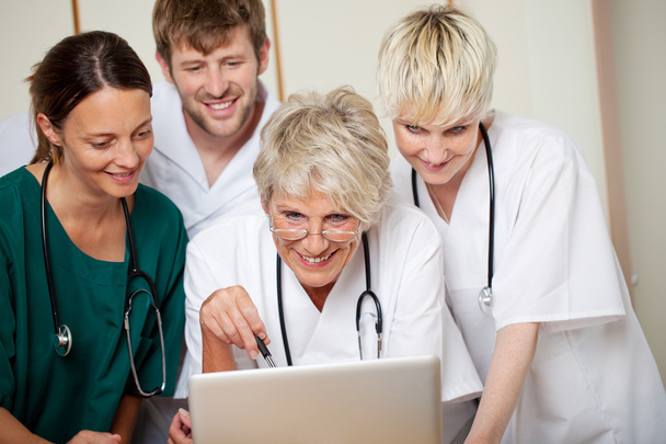 Smiling Doctors Looking At Laptop In Hospital - Fotografie, Obrázek