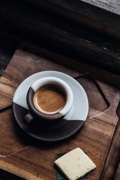 Espresso coffee in ceramic cup on wooden table - 写真・画像