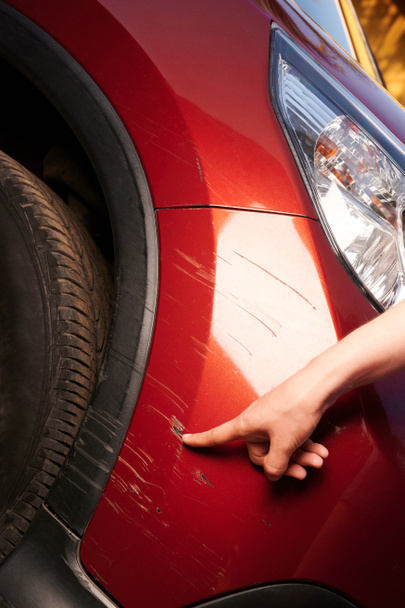 Κατεστραμμένο κόκκινο χρώμα αυτοκινήτου στον προφυλακτήρα - Φωτογραφία, εικόνα