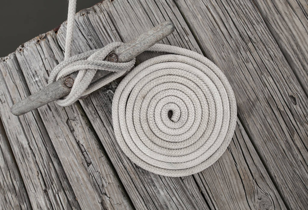 Coild of rope on weathered dock - Foto, imagen
