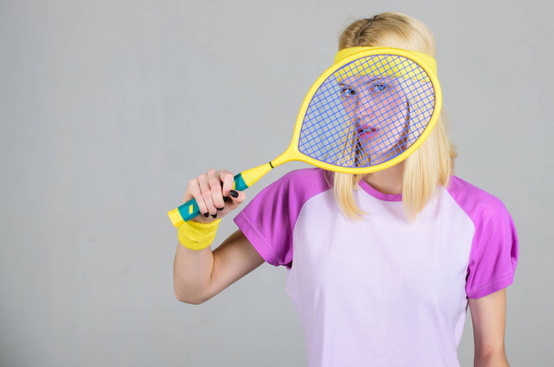 Sport for maintaining health. Athlete hold tennis racket in hand. Tennis club concept. Tennis sport and entertainment. Active leisure and hobby. Girl adorable blonde play tennis. Start play game - 写真・画像