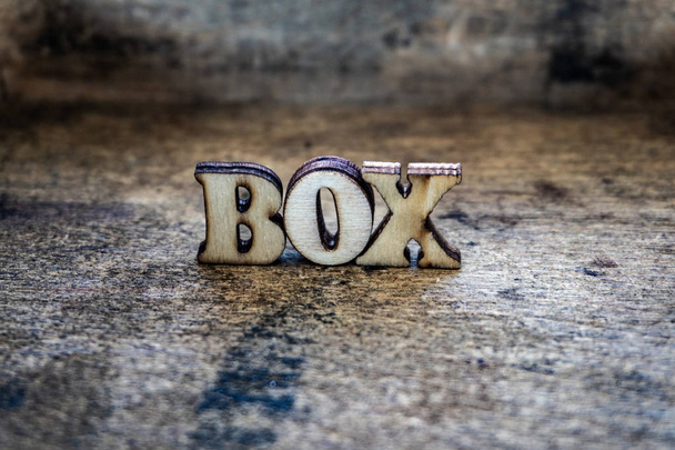 Box, wooden color letters, text on the board. Volumetric letters. - Photo, Image