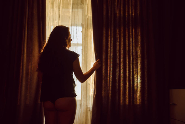 young sexy woman in panties opening curtains in the morning - Foto, Bild