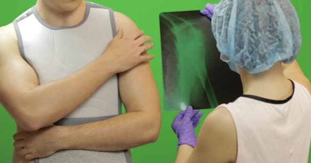 Man with shoulder injury. Nurse examines x-ray. Bandage for fixing shoulder - Footage, Video
