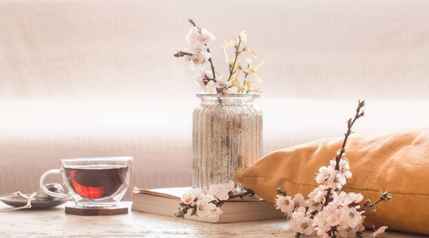 Lakberendezés a nappaliban csésze tea tavaszi virágok - Fotó, kép