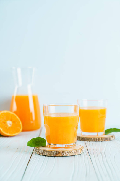 Fresh orange juice on wood background - Photo, image