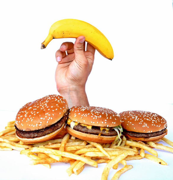 Mão fora de um monte de fast food
 - Foto, Imagem