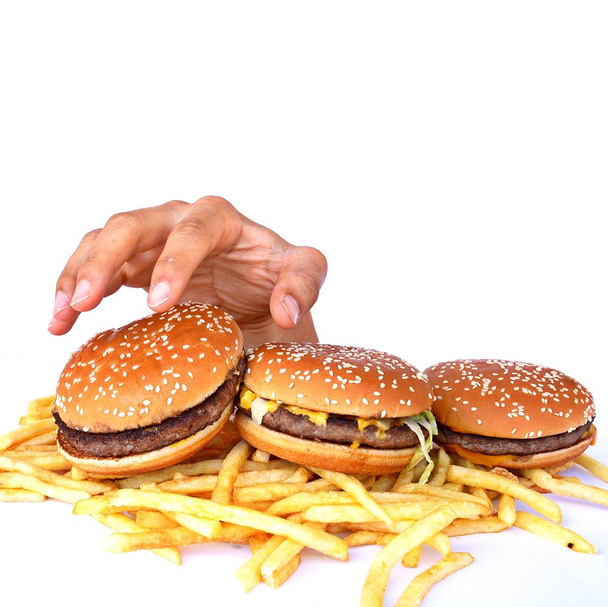 Mão fora de um monte de fast food
 - Foto, Imagem