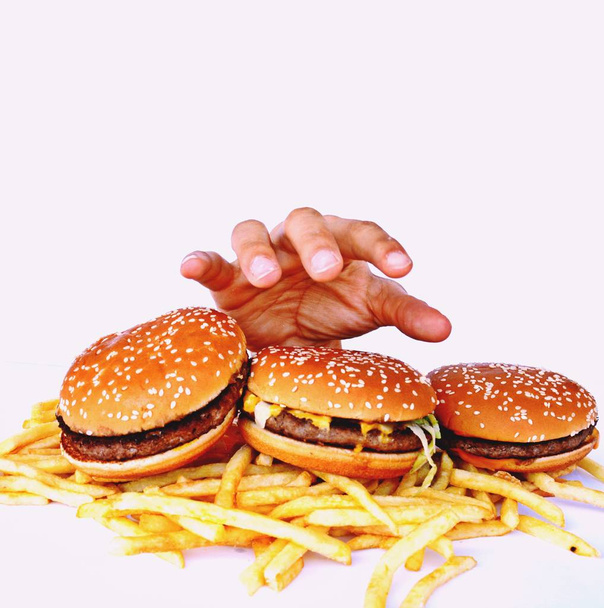 Hand out of a bunch of fast food - Photo, Image