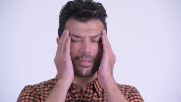 Face of stressed bearded Persian hipster man having headache - Footage, Video