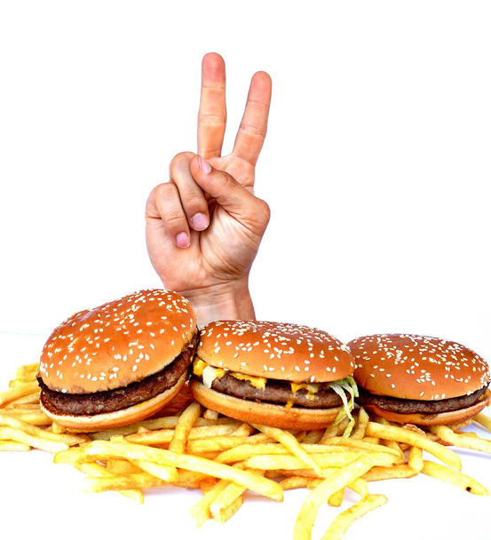Hand out of a bunch of fast food - Photo, Image