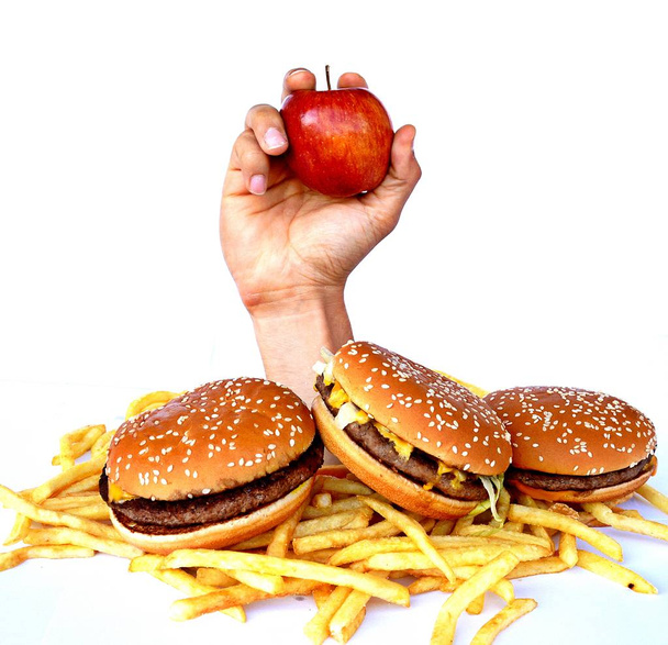 La mano de un montón de comida rápida
 - Foto, Imagen