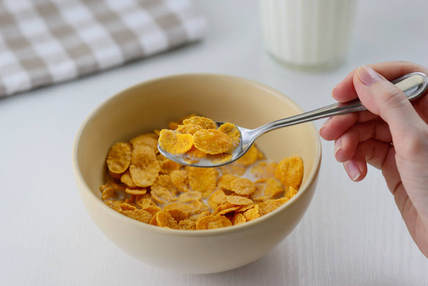 woman holding a bowl of cornflakes - Photo, Image