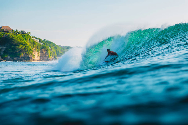 April 25, 2019. Bali, Indonesia. Surfer ride on barrel wave. Professional surfing with ideal ocean waves at Bingin beach - Φωτογραφία, εικόνα