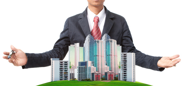 Business man and modern building on green grass field use for land management theme - Photo, Image