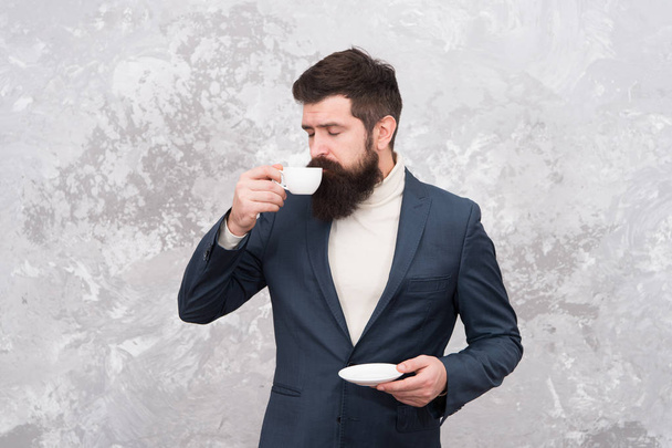 Male fashion model. Mature businessman. elegant man with beard drink coffee. Brutal bearded hipster in formal suit. Modern life. Tailor or fashion designer. Business without hurrying. Office routine - Photo, Image