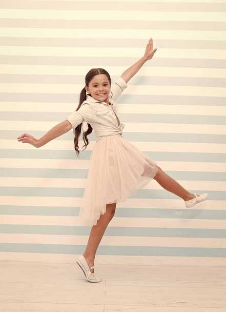 Child concept. Happy little child dancing. Child girl smile in fashion dress. Child and childhood. sense of freedom - Foto, immagini
