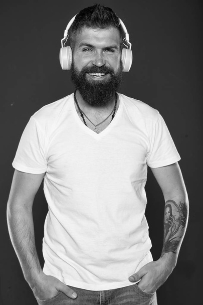 Hair and beard care. Bearded man. Confident and handsome Brutal man. Male barber care. Mature hipster with beard. man in headphones smiling while listening music. online education. man with tattoo - 写真・画像