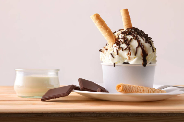 Cream and choco ice cream cup decorated with choco chips - Fotó, kép
