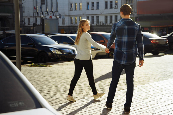 happy couple holding hands in the city, flirting, walking down the street. tourism - Φωτογραφία, εικόνα