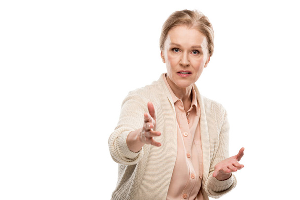 confused middle aged woman looking at camera and Gesturing with hands Isolated On White - Foto, imagen