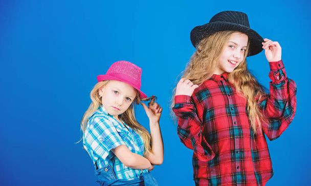 Following sister in everything. Girls kids wear fashionable hats. Small fashionista. Cool cutie fashionable outfit. Happy childhood. Kids fashion concept. Check out our fashion style. Fashion trend - Foto, imagen