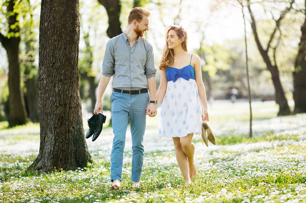 Couple enjoying romantic walk in nature barefoot - Foto, Bild