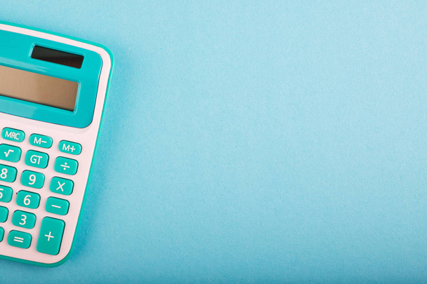 calculator on blue background. copy space for text - 写真・画像