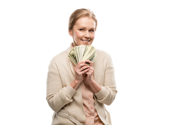 glückliche Frau mittleren Alters mit Dollarnoten auf weißem Grund - Foto, Bild