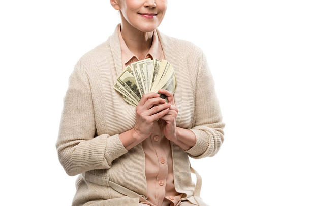 cropped view of middle aged woman with dollar banknotes Isolated On White - Foto, imagen