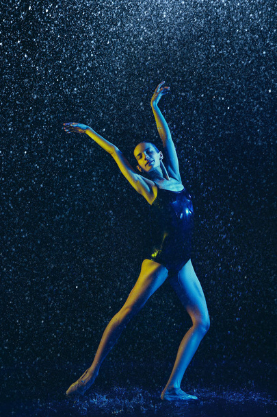 Two young female ballet dancers under water drops - 写真・画像