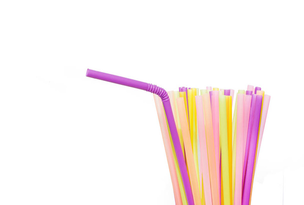 Many bright multi-colored plastic tubes for beverages on a white background. - Photo, Image