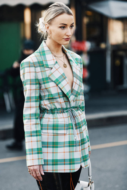 Milan, Italy - February 22, 2019: Street style Woman wearing a Coco Chanel necklace before a fashion show during Milan Fashion Week - MFWFW19 - Fotó, kép