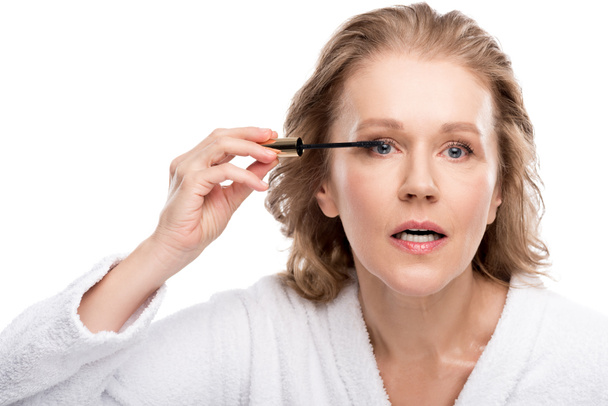 beautiful mature woman applying mascara Isolated On White  - Foto, Imagen