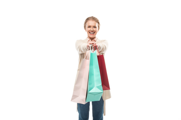 smiling middle aged woman with shopping bags Isolated On White with copy space - Photo, Image