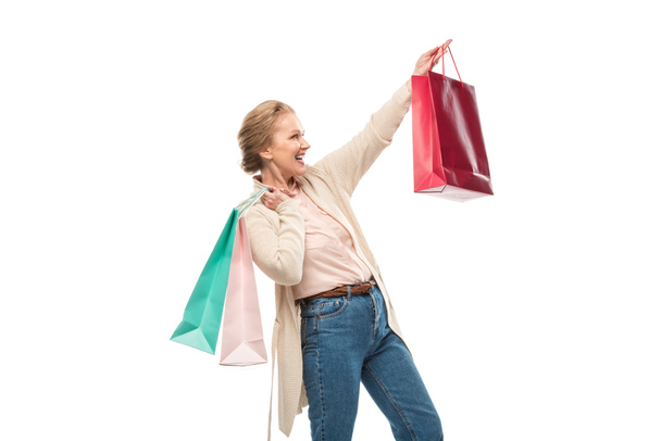 excited middle aged woman with shopping bags Isolated On White - Fotografie, Obrázek