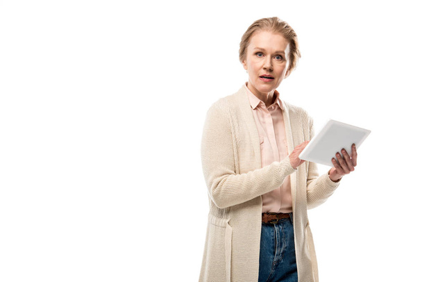 confused middle aged woman using Digital Tablet Isolated On White with copy space - 写真・画像