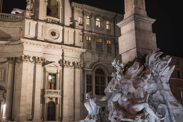 Statues of the obelisk of Piazza Navona by night in Rome - Photo, Image