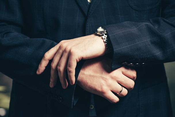 Hands of a businessman with a wristwatch closeup. - Фото, зображення