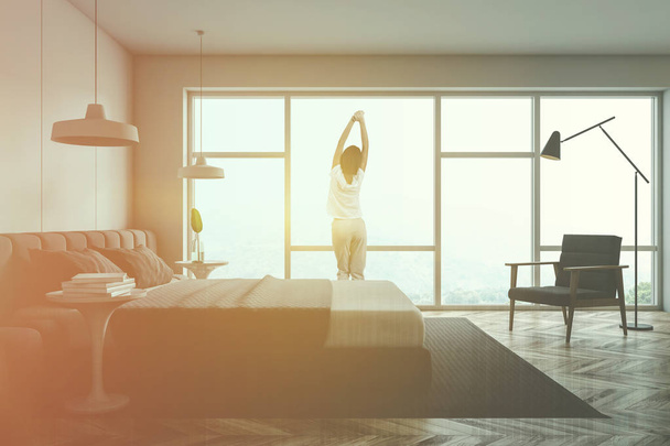 Woman in pajamas in panoramic bedroom - Zdjęcie, obraz