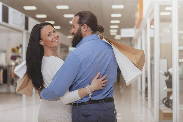 Happy mature couple shopping at the mall - 写真・画像