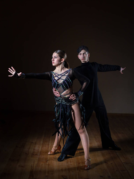 Krásní mladí tanečníci v tanečním sále izolováni na černém pozadí - Fotografie, Obrázek